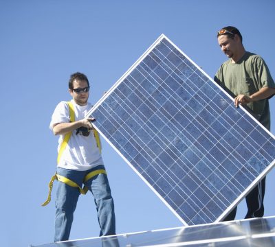 engineers holding solar panel