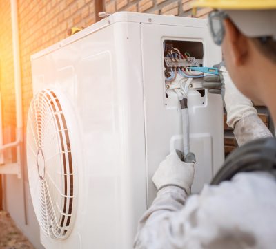 Air Conditioning Technician and A part of preparing to install new air conditioner. Technician vacuum pump evacuates and checking new air conditioner