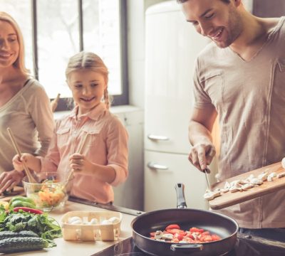 Photo of a young family cooking in a kitchen
